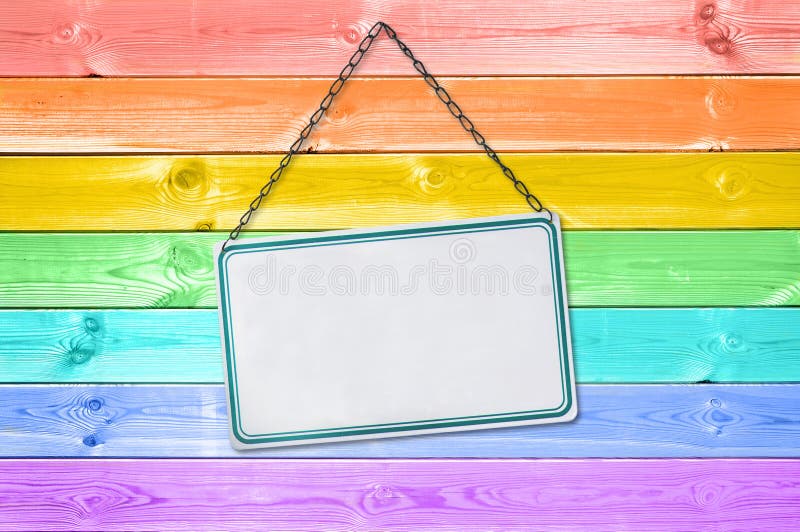 Metal plate sign hanging on a pastel colorful rainbow painted wood royalty free stock photo